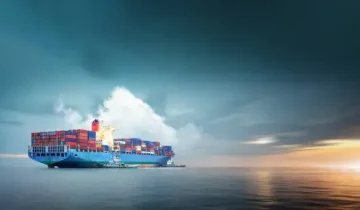 container-cargo-ship-in-ocean-at-sunset-dramatic-sky-background-with-copy-space-nautical